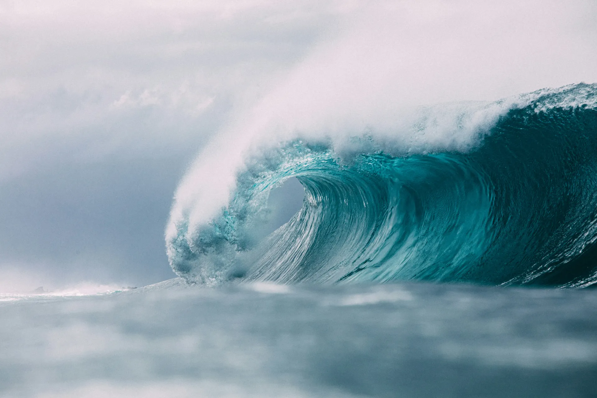A turquoise wave cresting along the coast
