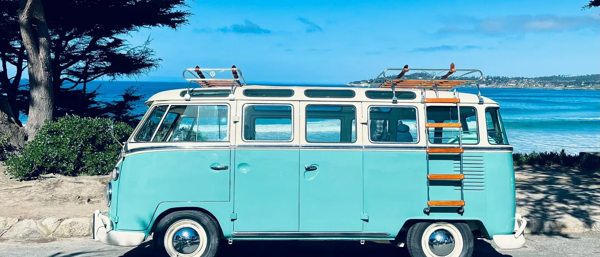 A vintage Volkswagen bus at a coastal overlook